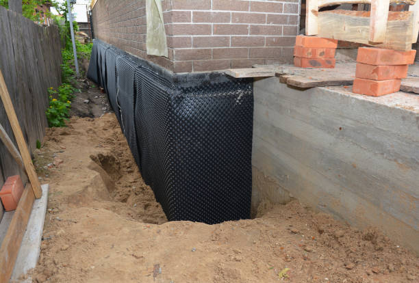 SJ Waterproofing Pros technician performing targeted Wet Basement Repair assessment in West Bloomfield, MI